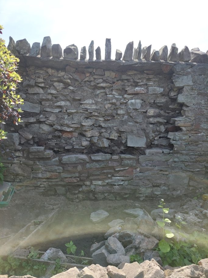 Damaged stone wall
